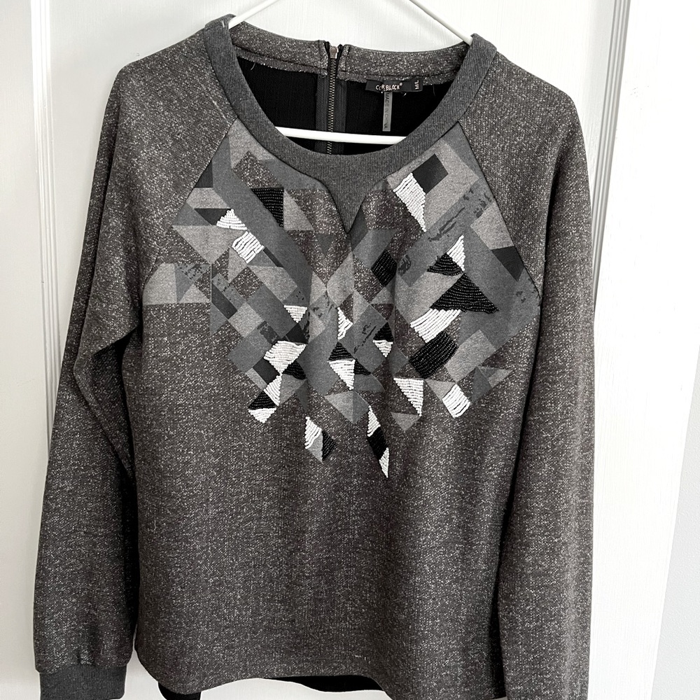 Beaded long sleeve knit top size medium. Very unique pattern.
